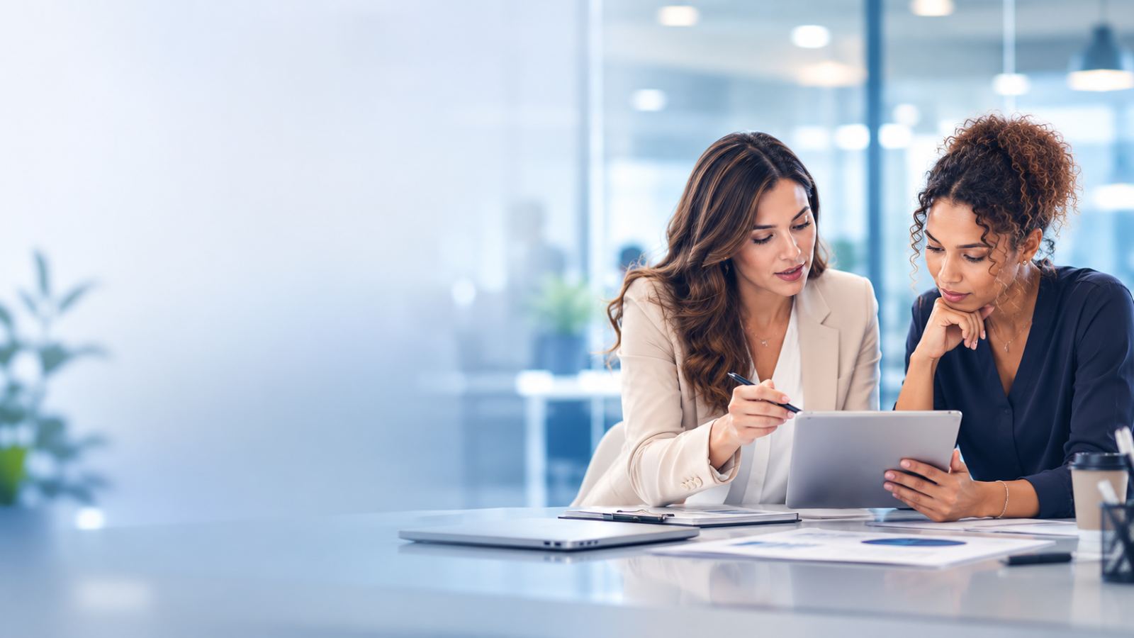Two healthcare operations specialists reviewing analytics together